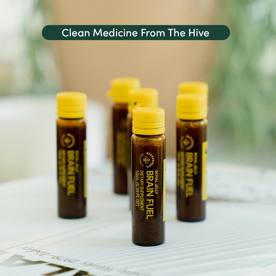 Beekeeper's Naturals Royal Jelly Brain Fuel vials with a notebook and pen