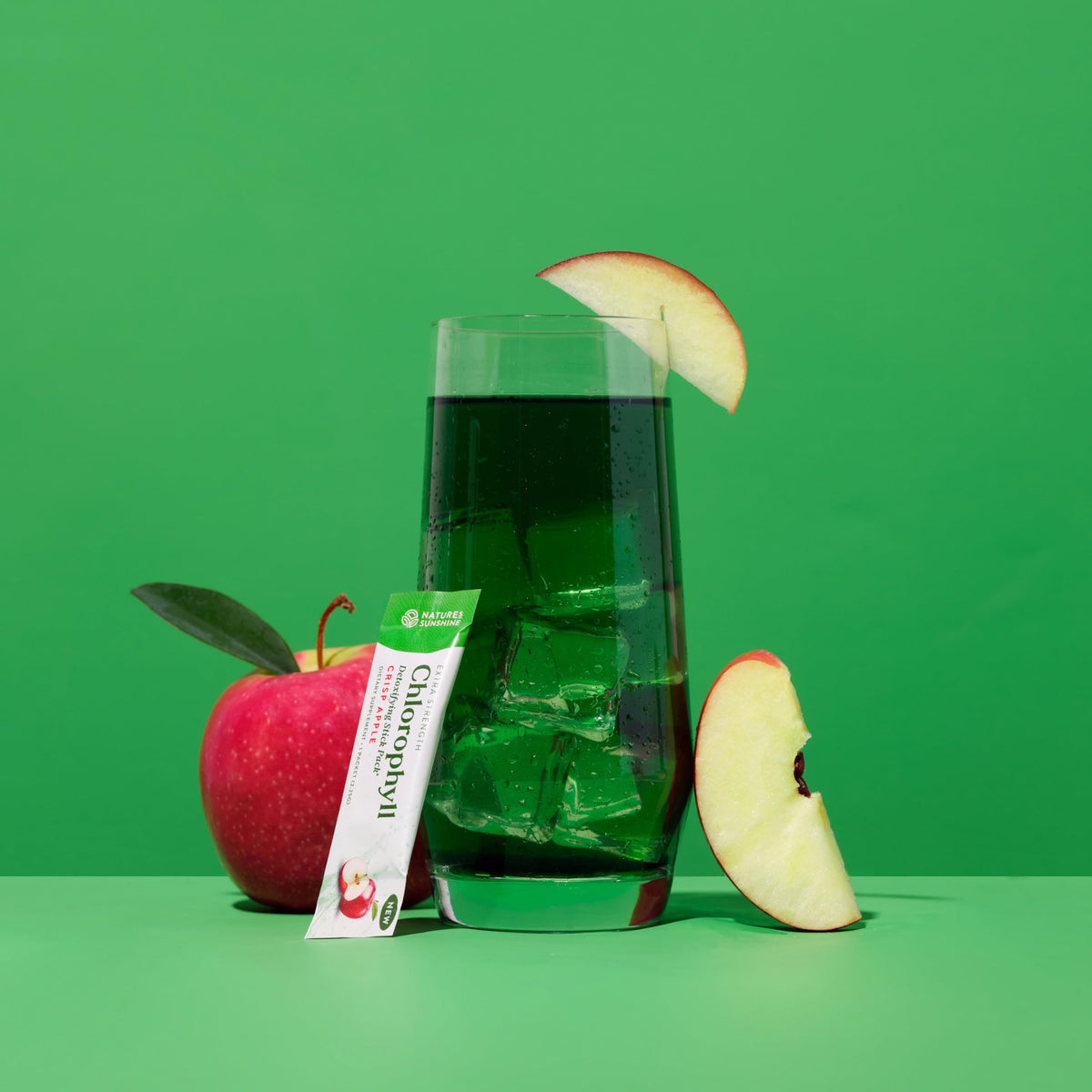 Close-up of Nature's Sunshine Chlorophyll Stick Pack with apple slices