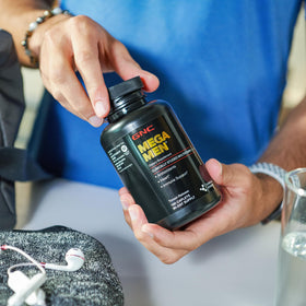 GNC Mega Men Multivitamin Caplets in lifestyle setting