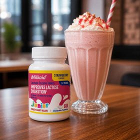 Milkaid Junior Lactase Enzyme Chewable Tablets with a glass of water