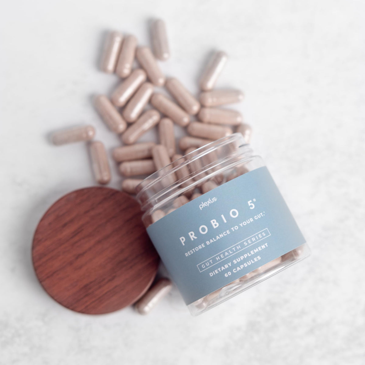 Plexus ProBio 5 capsules with a measuring spoon