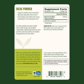 Spoonful of Banyan Botanicals Organic Bilva Powder on a wooden table