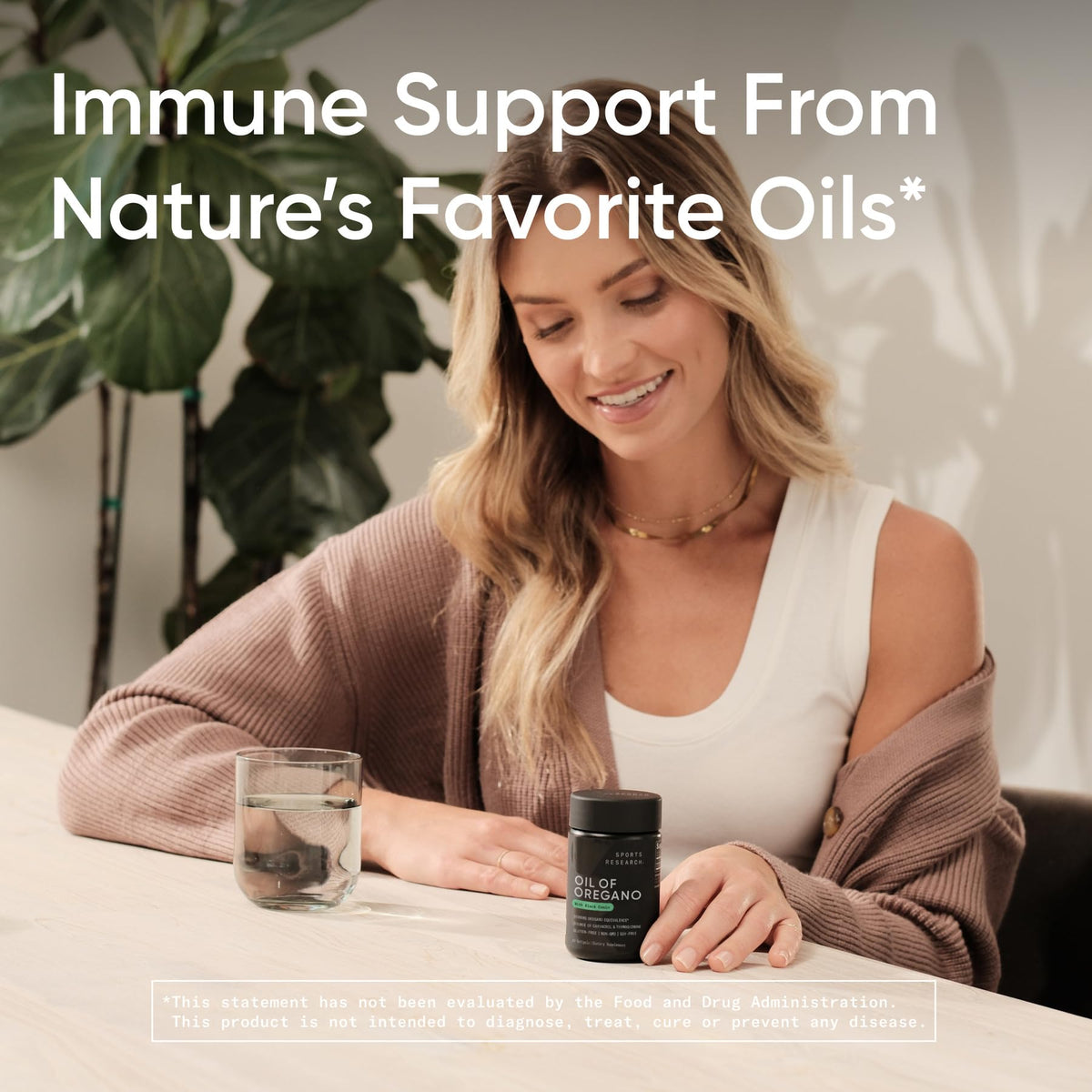 Sports Research Oil of Oregano 9500mg with Black Seed Oil softgels on a wooden table