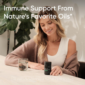 Sports Research Oil of Oregano 9500mg with Black Seed Oil softgels on a wooden table