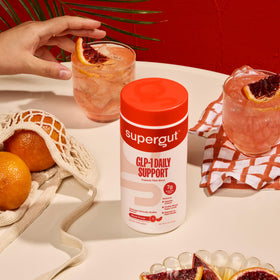 Supergut GLP1 Daily Support Blood Orange powder mixed in water
